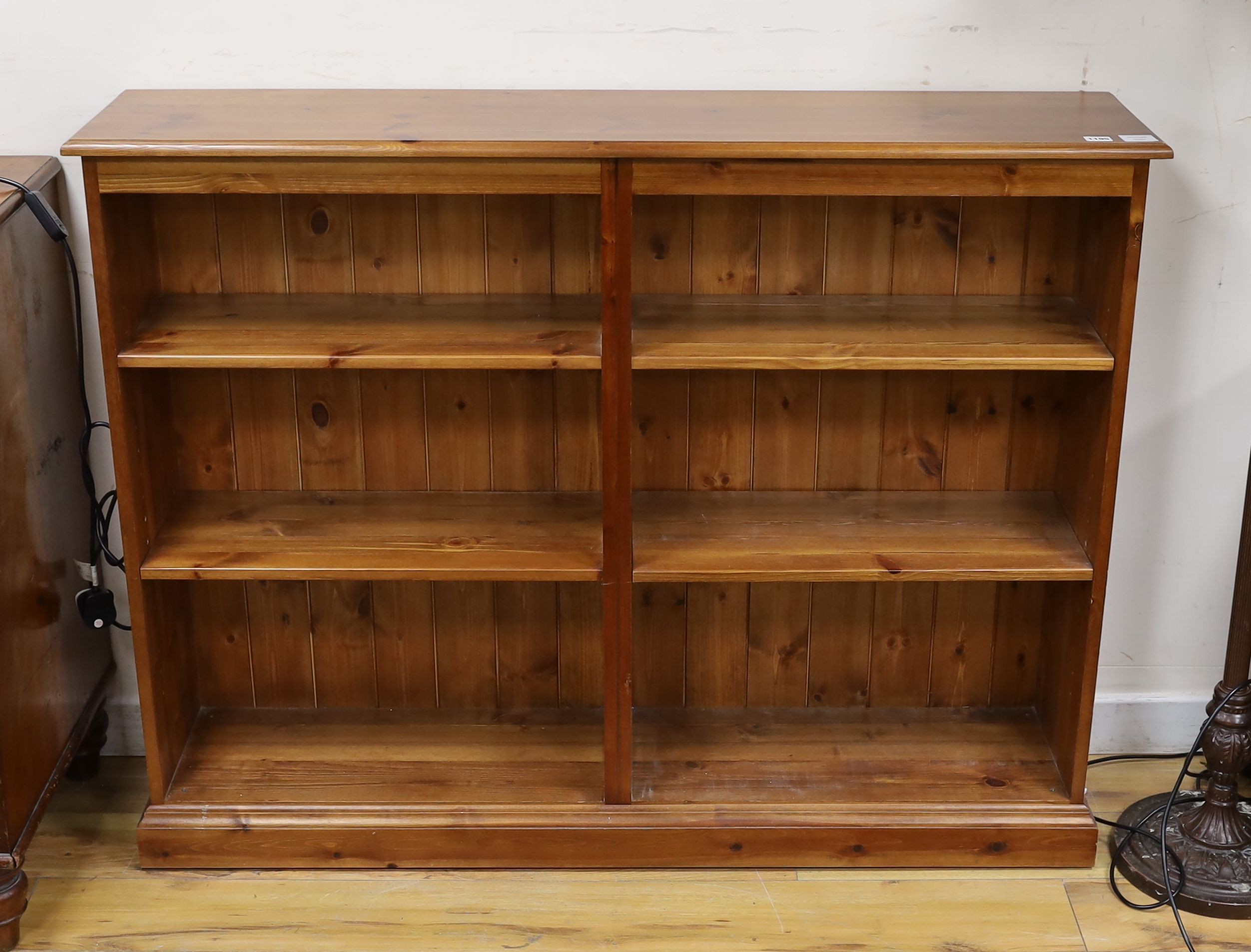 A modern pine open fronted bookcase, length 130cm, depth 29cm, height 100cm